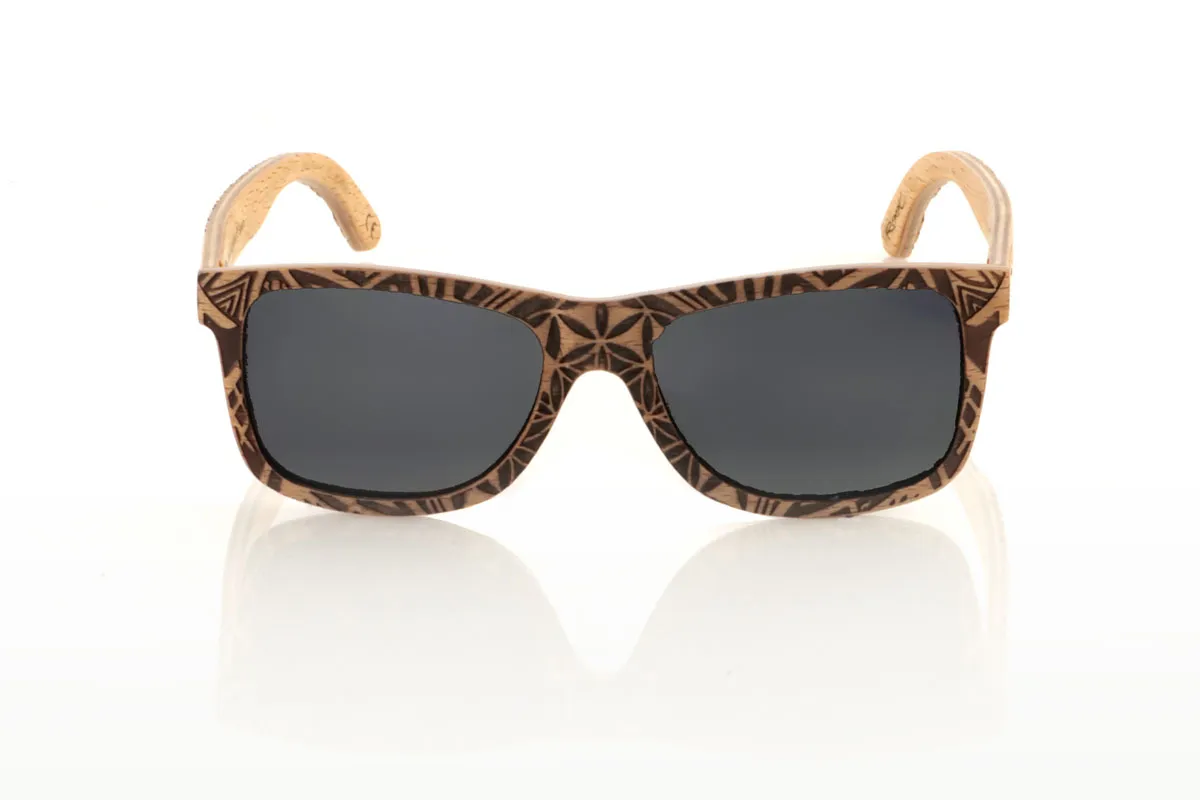 Wood eyewear of Beech MAURITANIA. The MAURITANIA wooden sunglasses have a shape inspired by the classics, made of beech wood. These glasses are distinguished by their exclusive finish engraved with an ethnic pattern, reflecting the arid tones of desert landscapes in every detail. Beech wood, in addition to its durability, provides a texture and color that makes each pair a unique piece. Designed for those looking for an accessory that stands out, the MAURITANIA are perfect for adding a touch of originality to your style. Measurement: 145x45. Caliber: 54. With them, you will take a piece of nature and adventure wherever you go. for Wholesale & Retail | Root Sunglasses® 